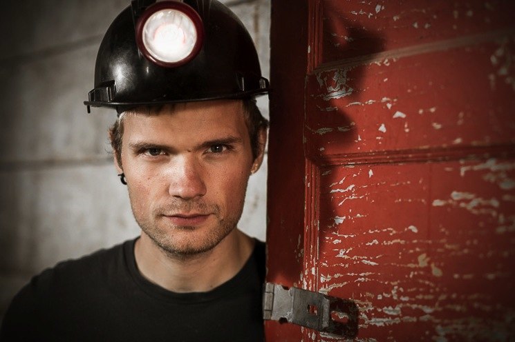 85mm portrait lens example image, a young miner with safety helmet