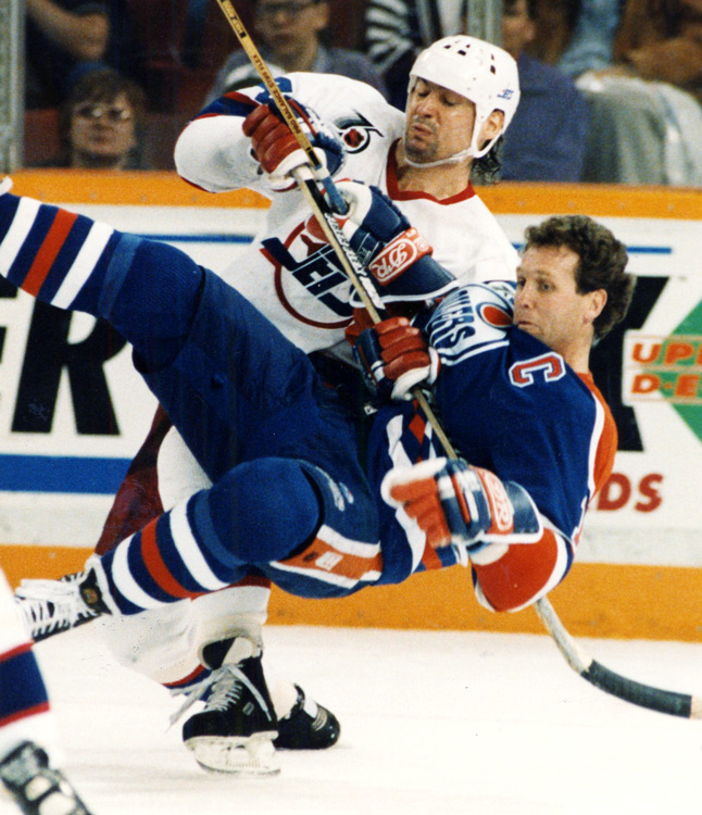 Hockey player seems to be in mid air after a collision with another player