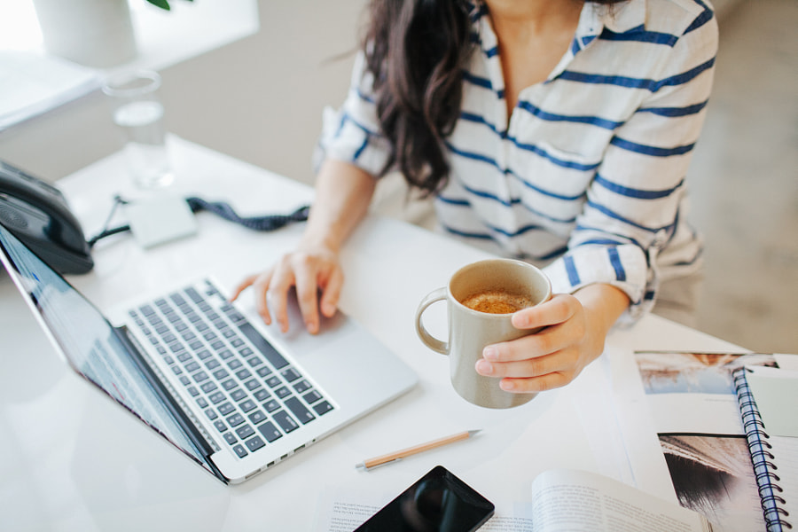 Young businesswoman working on laptop at desk by EasyPx on 500px.com