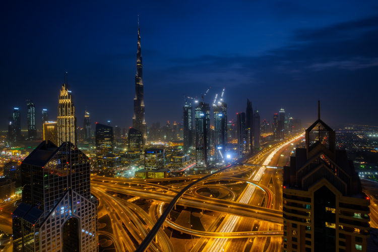 Dubai at night showing freeways and car light trail technique