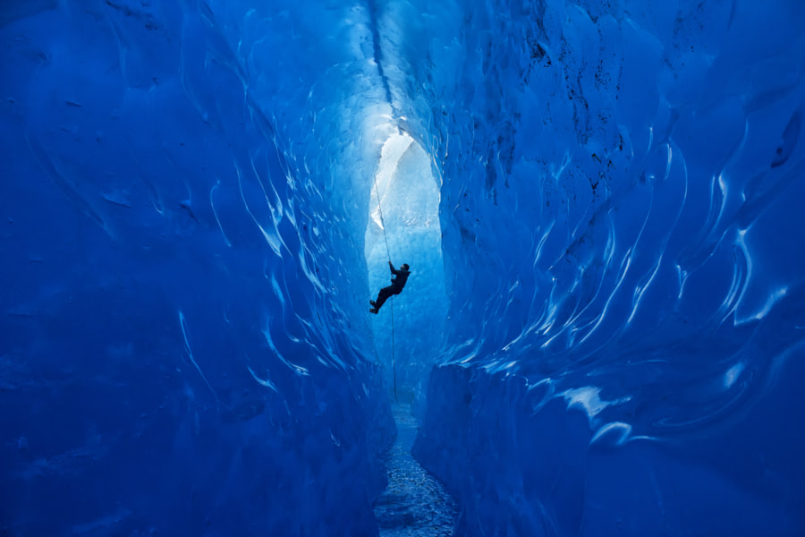 Climber Rappelling Into Cave by Jared Carlson on 500px.com