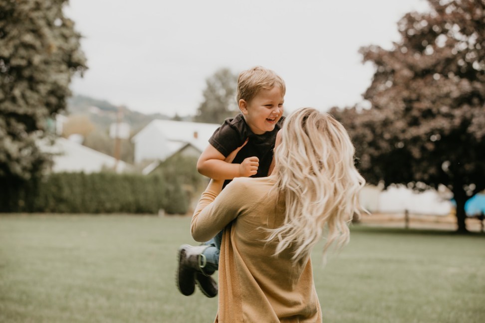 woman twirling boy