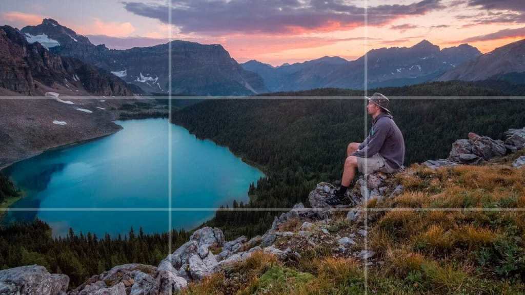 A hiker looking over a lake with rule of thirds lines superimposed