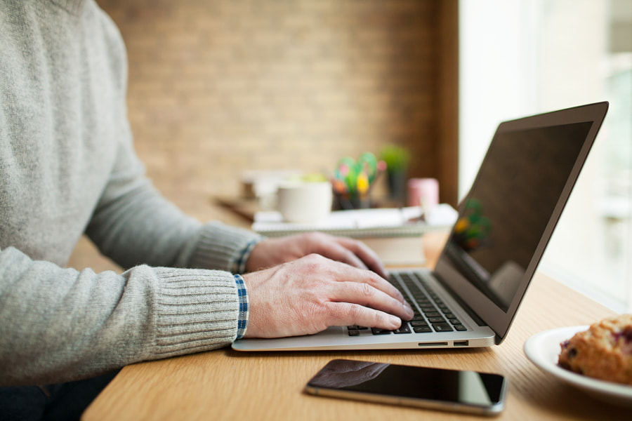 Businessman working on laptop at desk. by EasyPx on 500px.com