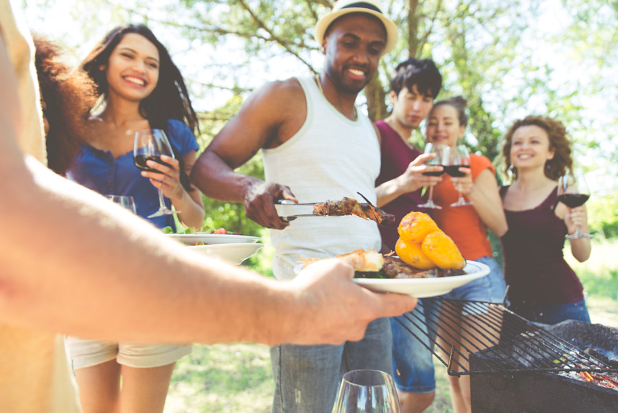 Group of friends making barbecue in the nature. Eating and shari by Cristian Negroni on 500px.com