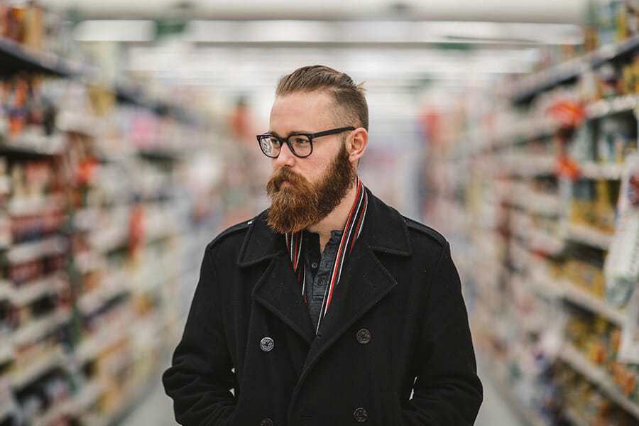 A sample photo of a man in a bookstore. Taken witha  shallow depth of field.