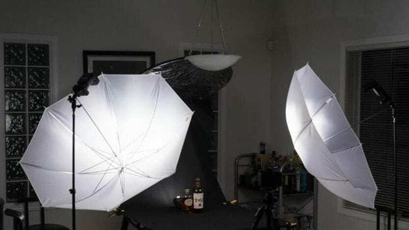 A shoot through umbrella being used in a food photo session.