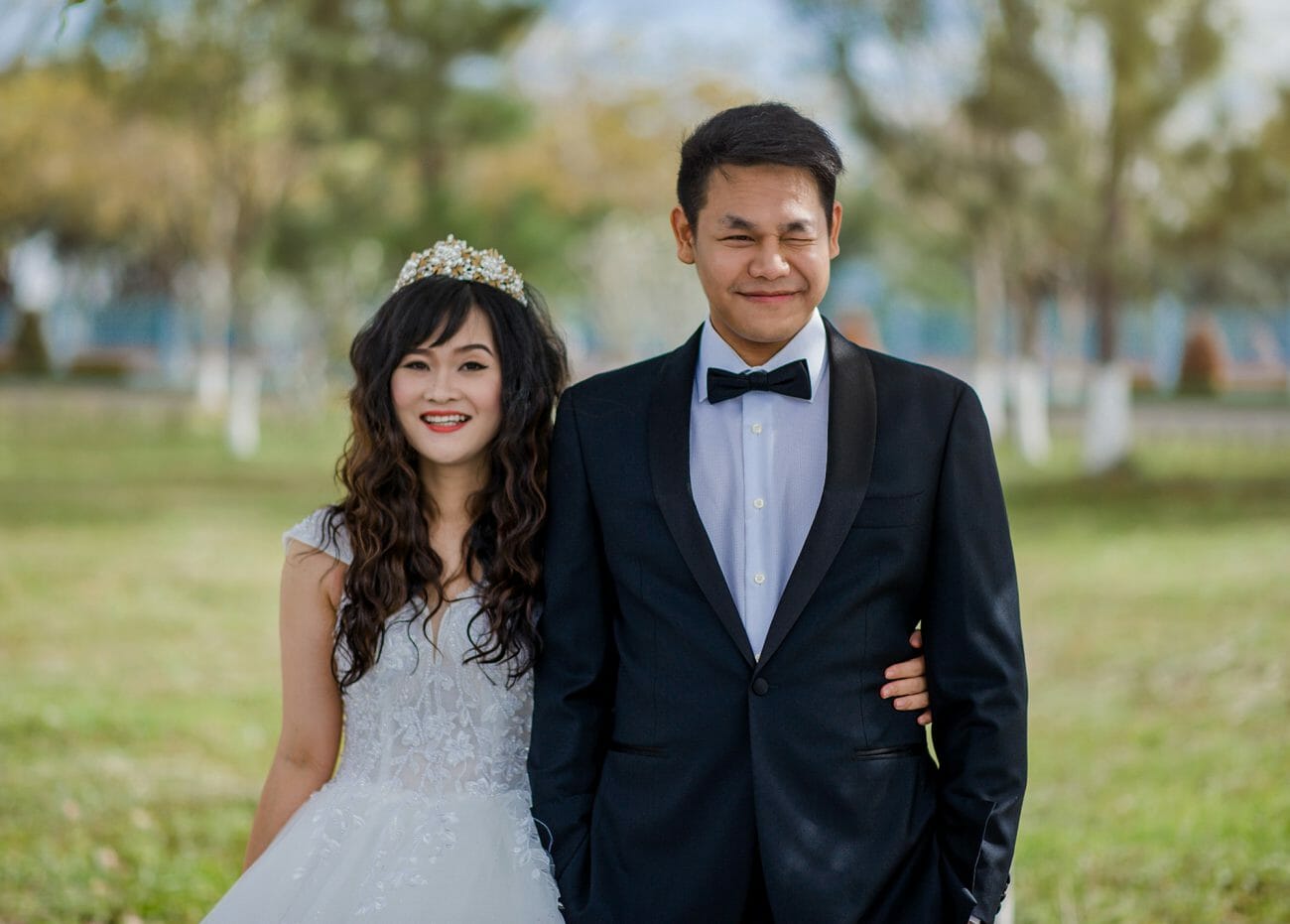 A bride and groom smiling and being silly