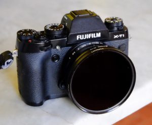 A screw-in filter attached to a DSLR lens