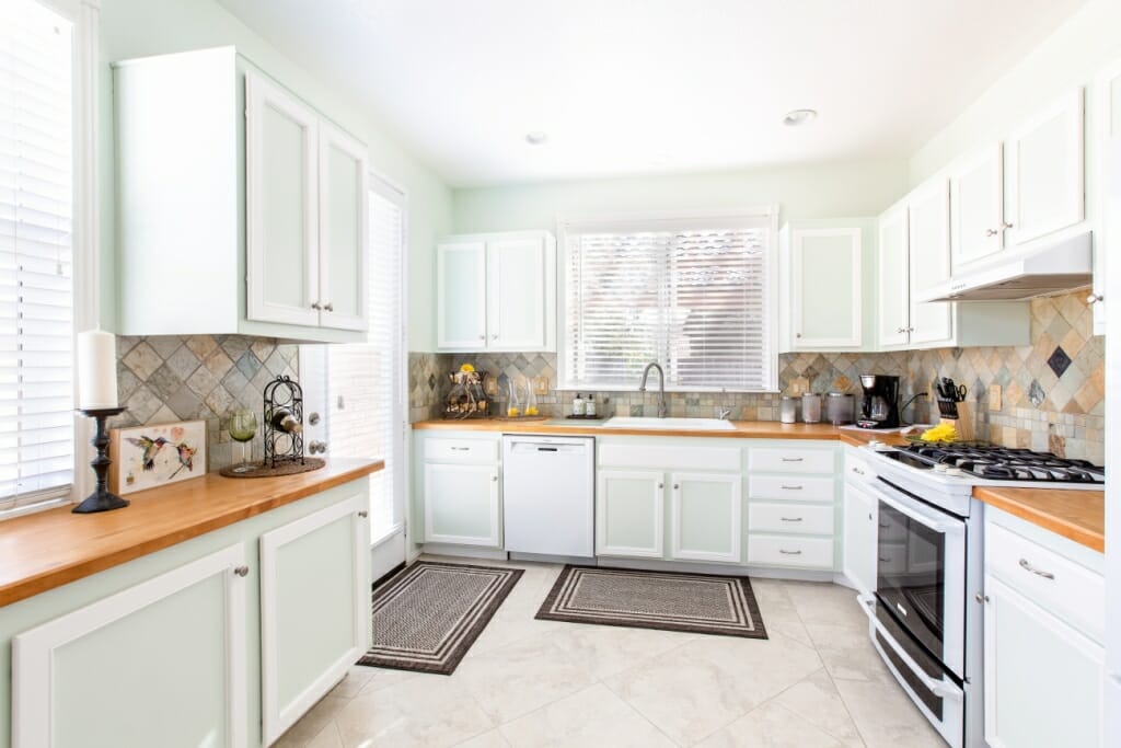 A wide angle real estate photograph of a kitchen