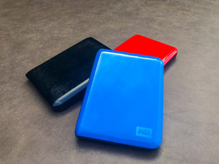 a red blue and black portable external hard drives help ensure data integrity when traveling or on the road