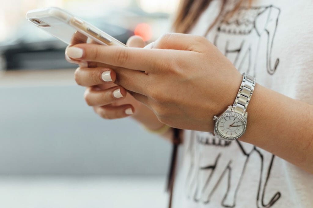 A photo of a girl's hands holding a smartphone