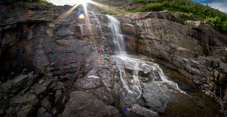 photographing a waterfall while shooting into the sun