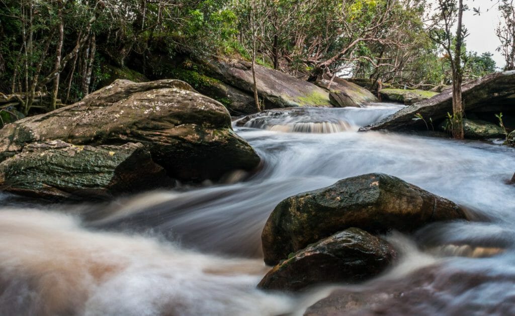 A silky stream flows between rocks