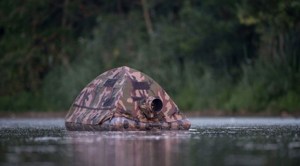 A man on a floating blind shooting wildlife photography