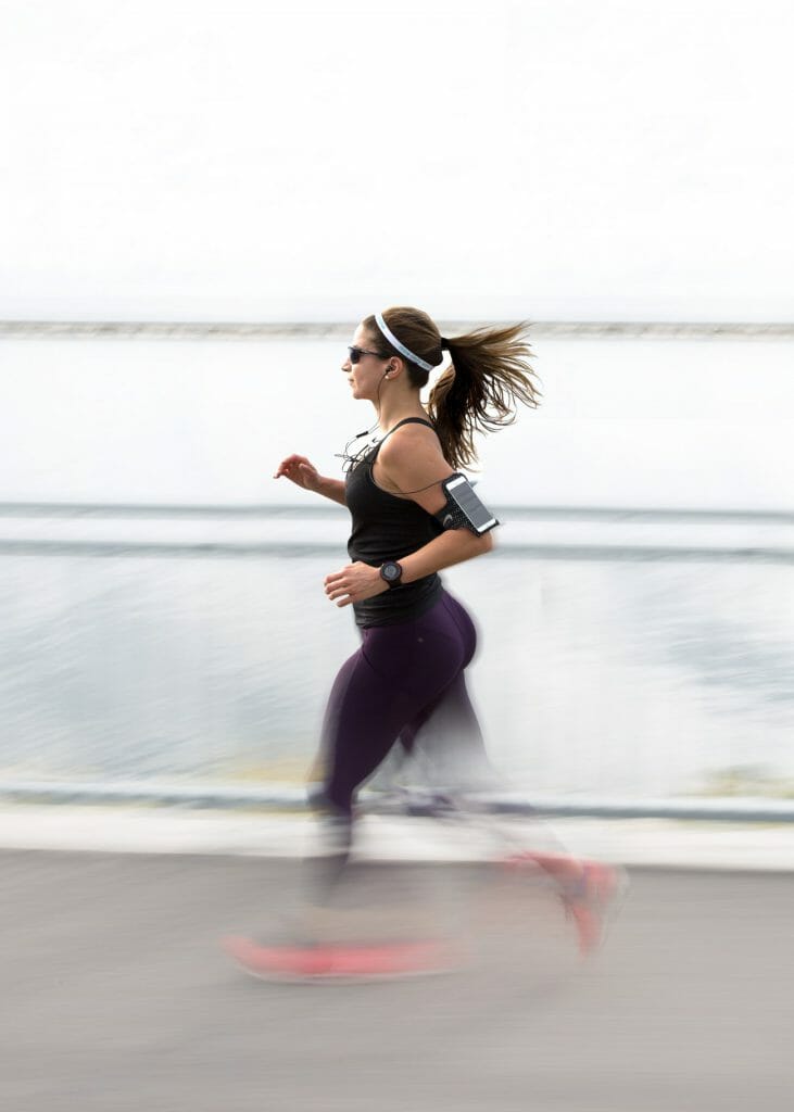 A panning photo of a woman jogging