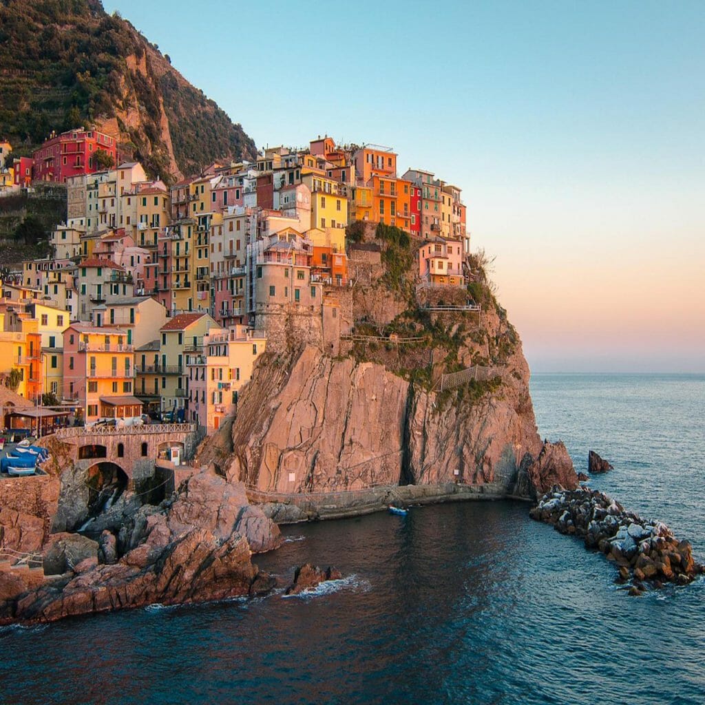 A sunset image of a colorful Italian coastline