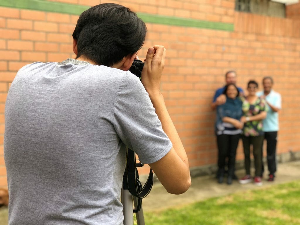 A man photographing a family
