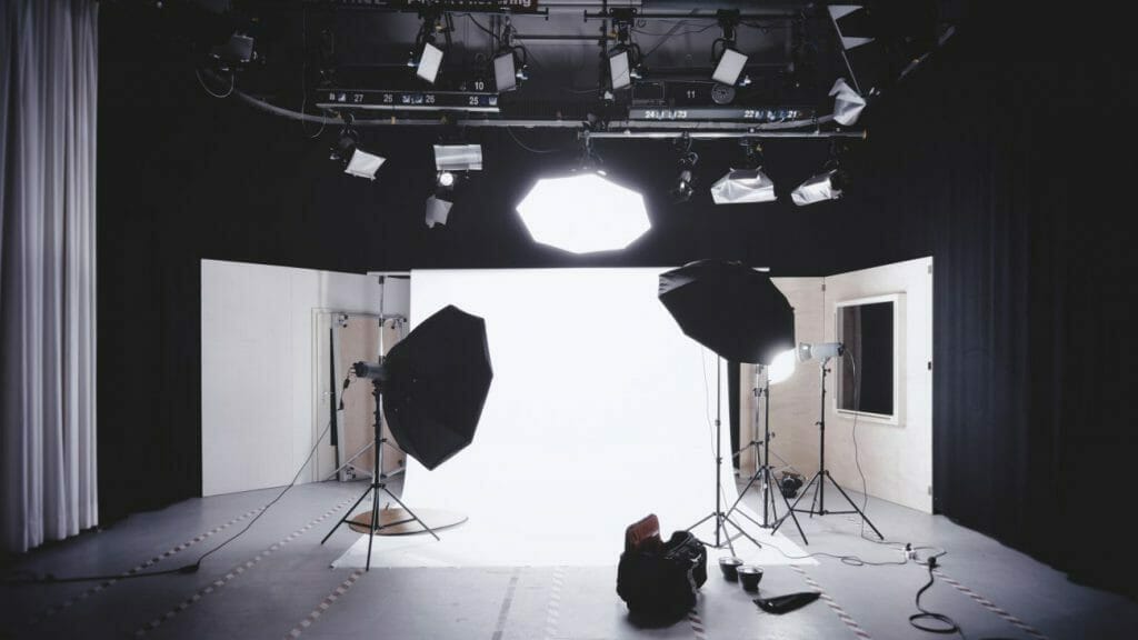 A photography studio complete with white backdrop and studio lights - operating costs to consider in photography pricing