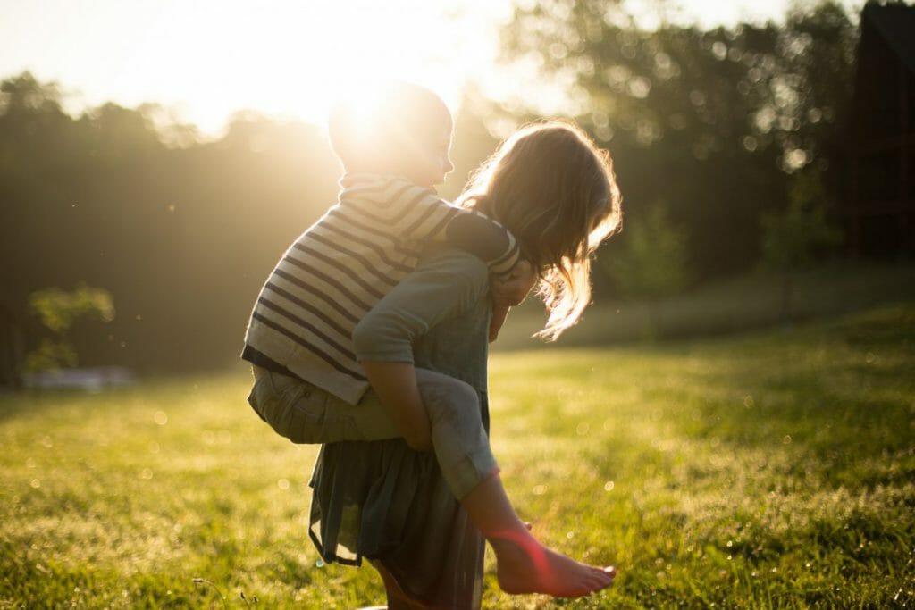 A family photography of two kids playing in golden hour