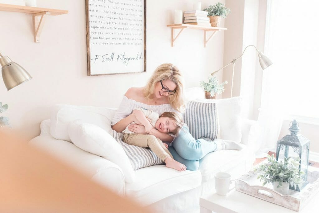 A photo of a playful son and mother posing for a family photography session.