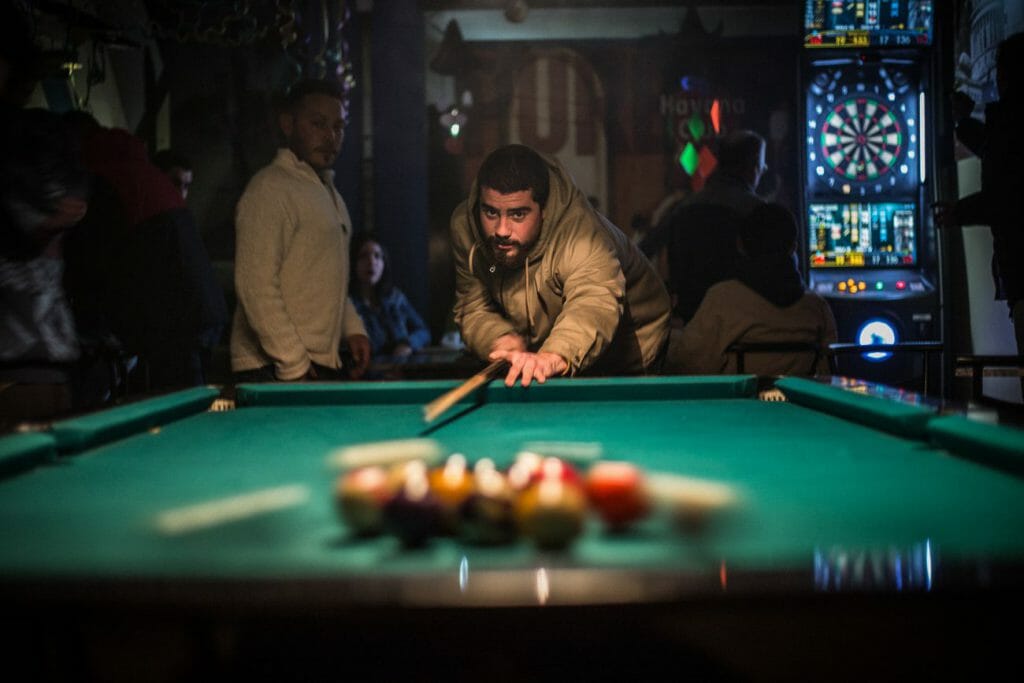 A photo of a person playing billiards in a room