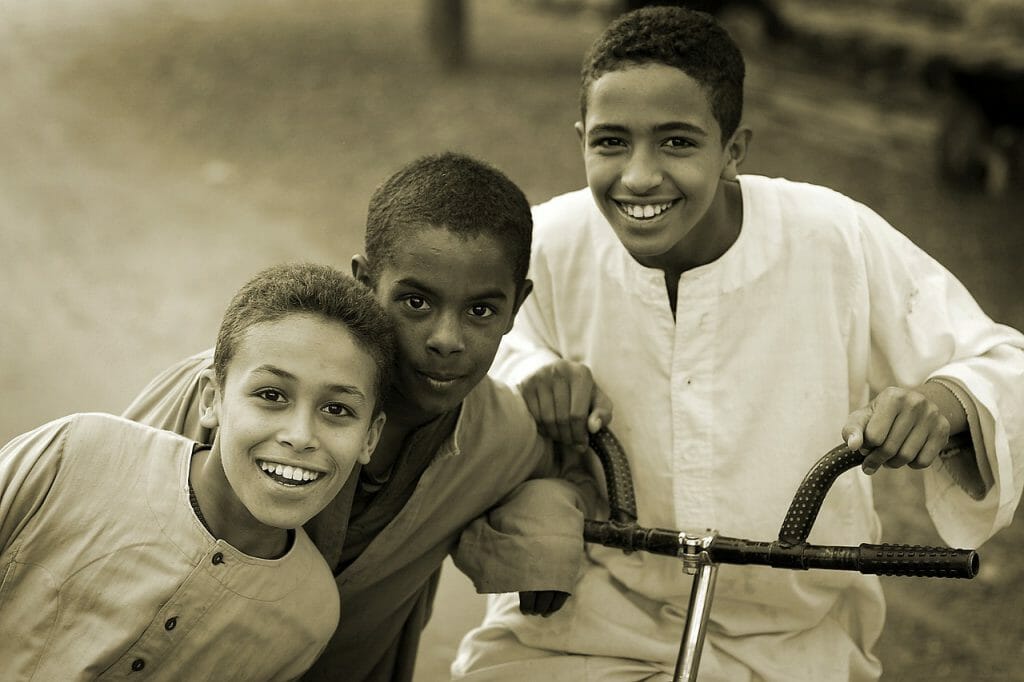 three kids posing for a photograph.