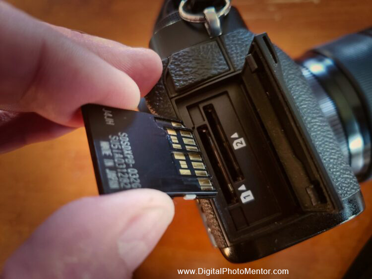 insert the memory card into the camera slot carefully and slowly with the pins lined up correctly