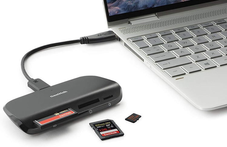 sandisk card reader product photo showing a memory card instered into reader and then attached to computer to download the files