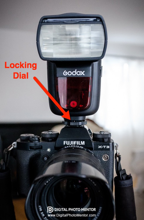 Attach flash to camera hot shoe and lock it in place with locking dial to secure it
