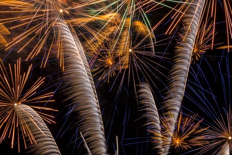 horizontal photo of fireworks bursting overhead photographed with a tight composure to make an abstract photo