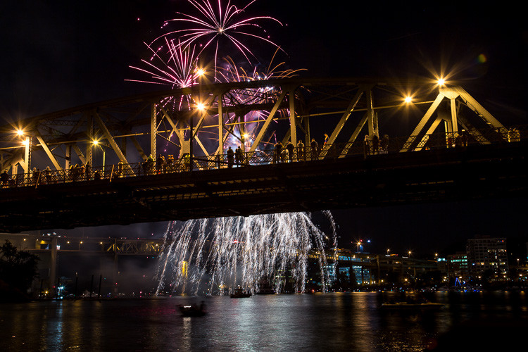 A new composition with a tigher shot with fireworks bursting and creating stars behind the bridge showing the crowd in silhouette but still not great