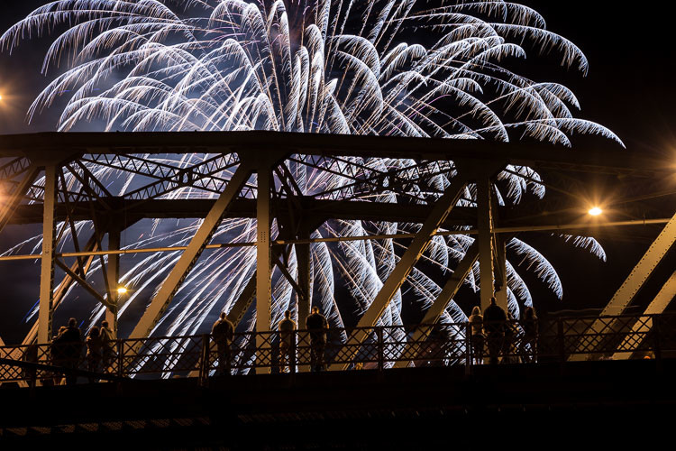 beautiful fireworks streaking out from it's burst with bridge and people for effect ISO 200, f/8, 2.5 seconds - shot at 90mm.