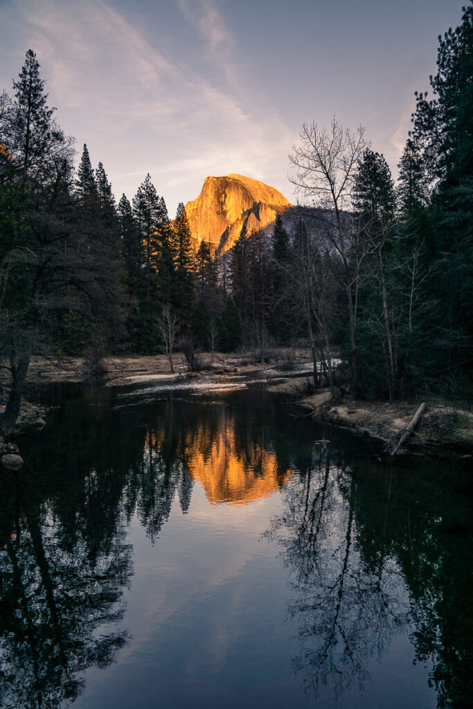 Half dome at sunset reflected in the lake and shot in portrait orientation (vertical)