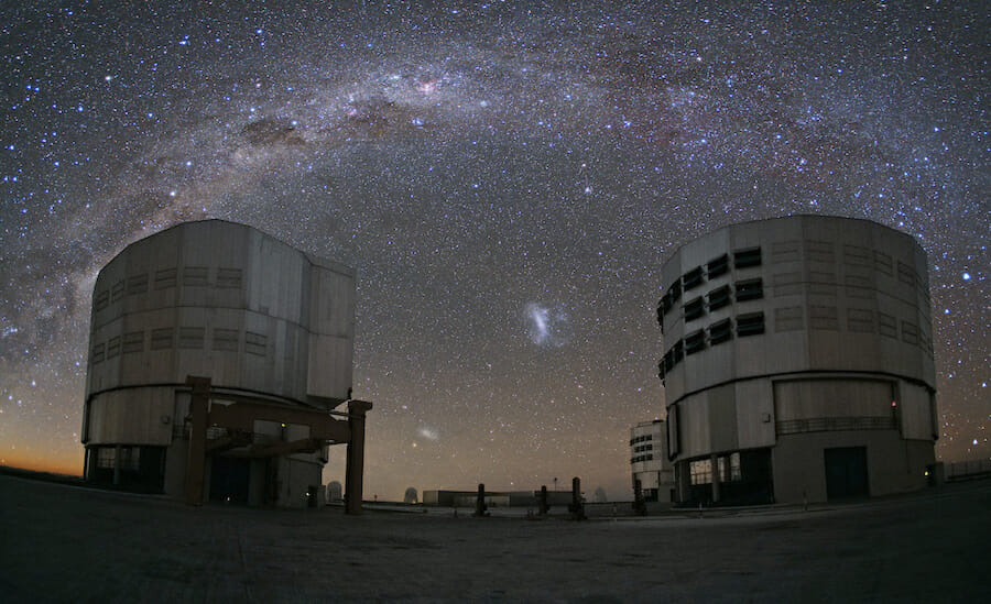 An image of the Milky Way arching over the telescopes at the ECO Paranal Observatory in the Atacama Desert, Chile.