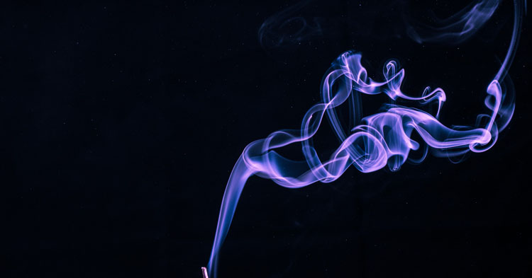 creative photo of smoke trails coming off a stick of incense