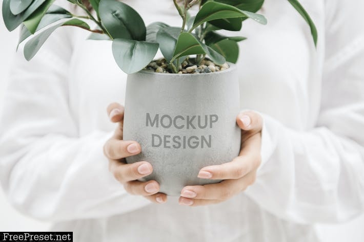 Woman holding a gray plant pot mockup G589K88